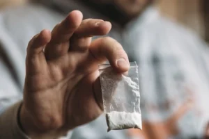 hand-holding-packet-of-cocaine
