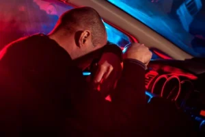 man-head-steering-wheel-police-lights