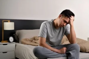 worried-man-sitting-on-bed