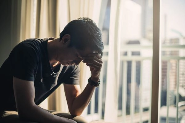 worried-man-sitting-by-sunny-window